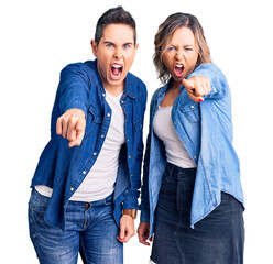 Couple of women wearing casual clothes pointing displeased and frustrated to the camera, angry and...