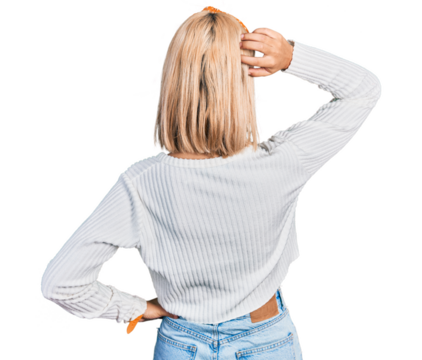 Beautiful young blonde woman wearing casual white sweater backwards thinking about doubt with hand on head