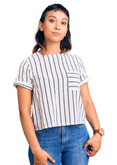 Fototapeta premium Young woman wearing casual clothes relaxed with serious expression on face. simple and natural looking at the camera.