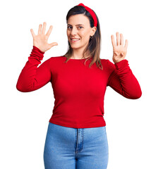 Young beautiful woman wearing casual clothes showing and pointing up with fingers number nine while...