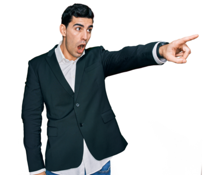 Handsome hispanic man wearing business clothes pointing with finger surprised ahead, open mouth amazed expression, something on the front