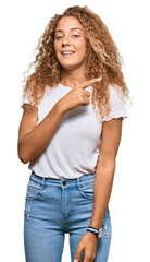 Obraz premium Beautiful caucasian teenager girl wearing casual white tshirt cheerful with a smile on face pointing with hand and finger up to the side with happy and natural expression