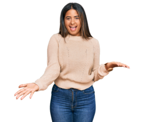 Young latin girl wearing wool winter sweater smiling cheerful with open arms as friendly welcome, positive and confident greetings