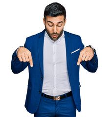 Young hispanic man wearing business jacket pointing down with fingers showing advertisement, surprised face and open mouth © Krakenimages.com