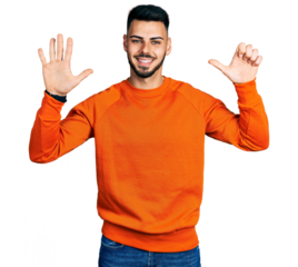 Young hispanic man with beard wearing casual orange sweater showing and pointing up with fingers number six while smiling confident and happy.