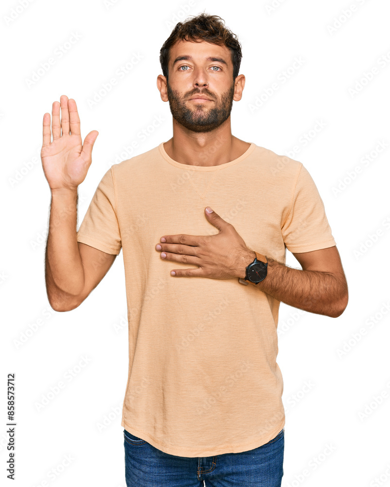 Poster handsome young man with beard wearing casual tshirt swearing with hand on chest and open palm, makin