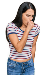 Young hispanic girl wearing casual striped t shirt feeling unwell and coughing as symptom for cold or bronchitis. health care concept.