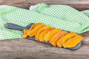 Sliced Dried Mango, Dried Fruit. Candied fruits, mango pieces. Background from orange dried mangoes...