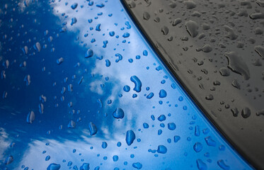 Abstract blue and black reflective metal surface with water droplets background         