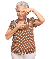 Senior grey-haired woman wearing casual clothes smiling making frame with hands and fingers with happy face. creativity and photography concept.