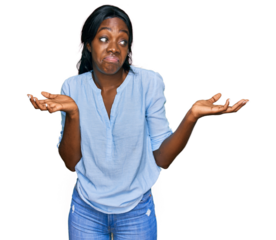 Young african american woman wearing casual clothes clueless and confused expression with arms and hands raised. doubt concept.