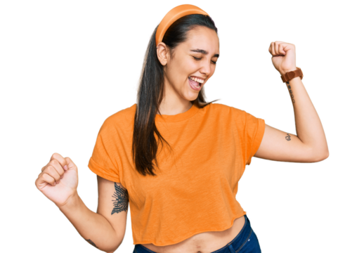Young hispanic woman wearing casual clothes dancing happy and cheerful, smiling moving casual and confident listening to music