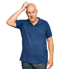 Middle age bald man wearing casual clothes confuse and wonder about question. uncertain with doubt, thinking with hand on head. pensive concept.