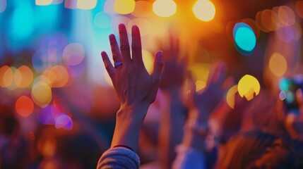 Even in defocused form the hands raised in praise at the outdoor church service exude a sense of devotion and connection.
