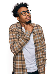 Young african american man with beard wearing casual clothes and glasses touching painful neck, sore throat for flu, clod and infection