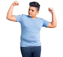 Little boy kid wearing sports workout clothes showing arms muscles smiling proud. fitness concept.