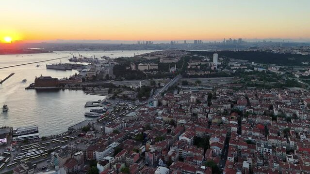 Sunset bird's eye view from aerial drone shooting of Kadikoy Port, Haydarpasa, harem and Bosphorus in the background, streets, people walking cars, Istanbul Kadikoy