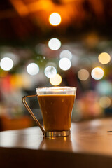 A glass of coffee on a table in a cafe