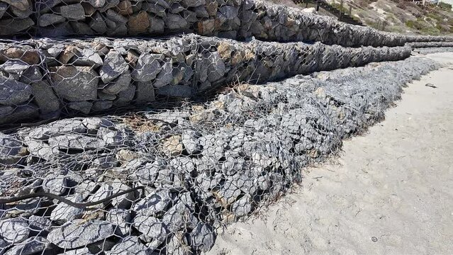 Langebaan west coast South Africa.  Rock filled cages piled to protect the sand dunes from the sea.