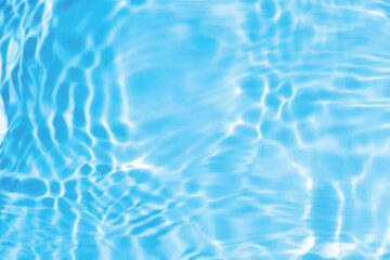 Blue water with ripples on the surface. Defocus blurred transparent blue colored clear calm water surface texture with splashes and bubbles. Water waves with shining pattern texture background.