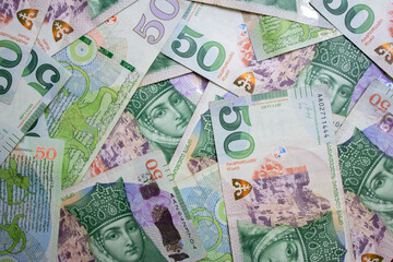 Top view. 50 GEL. Georgian lari. Photo close up. Green paper banknotes of Georgia. Cash money. Portrait of Queen Tamara. Female face. Concept of tax, debt, currency exchange, loan. Bill. Bank note