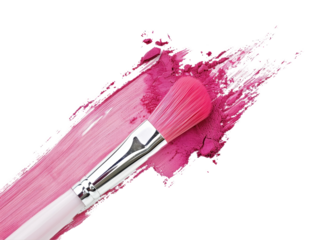A makeup brush is on a pink background