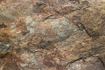 Mountain rock texture. Natural brown slate granite slab marble stone ceramic seamless tile rough surface background.