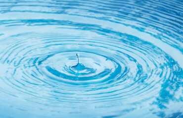 A drop of rain falls into the water and leaves circles