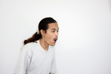 Asian man who is surprised and makes an expression of wanting to gossip. isolated in white background