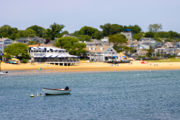 Houses, beach and boat tilt shift