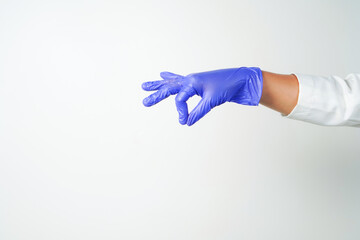 Doctor or nurse hand in sterile gloves in holding position isolated on white