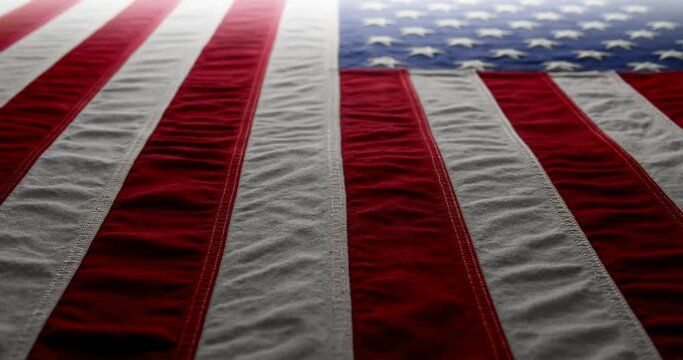 Panning across a brightly lit, red white and blue, US American flag. Background for Memorial Day, Veteran's Day, 4th of July, or other patriotic USA holiday.