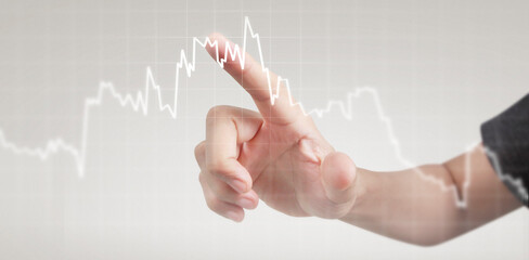 Hand touching graphs of financial indicator and accounting market economy analysis chart