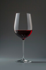 A sleek wine glass filled with red wine, set against a dark, minimalist background, highlighting elegance, sophistication, and fine dining.