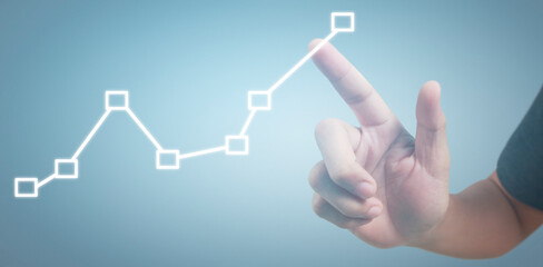 Hand touching graphs of financial indicator and accounting market economy analysis chart