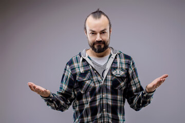 Bearded man showing indecision with open arms gesture