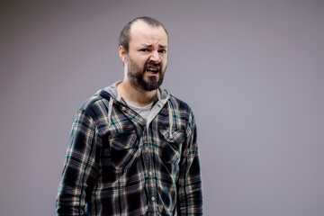 Bearded man making a face expressing disgust