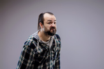 Fototapeta premium Bearded man with checkered shirt making a funny face expression