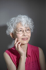 Close-up of woman with gray hair looking up Skin care and beauty image Touching cheeks