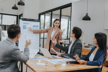 Professional team, including businessmen and businesswomen, engages in a strategy meeting. They discuss marketing, analyze financial data, and brainstorm investment plans using charts, graphs,