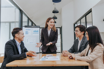 Professional team, including businessmen and businesswomen, engages in a strategy meeting. They discuss marketing, analyze financial data, and brainstorm investment plans using charts, graphs,