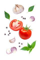 Tomato with basil leaves, garlic, onion and black pepper flying in the air isolated on white background.