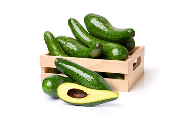 Long avocado fruit in wooden box isolated on white background.