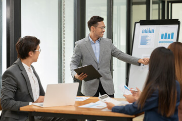 Asian Business Group Chat about graph work Present in meetings, in the office