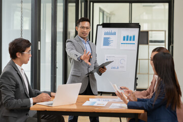 Asian businessmen, women and men Talk about new projects, presents at home office.