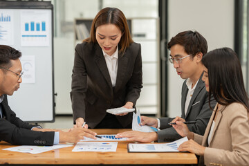 Asian businessmen, women and men Talk about new projects, presents at home office.
