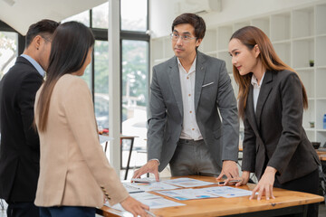 Group of business people meeting and present work on the board