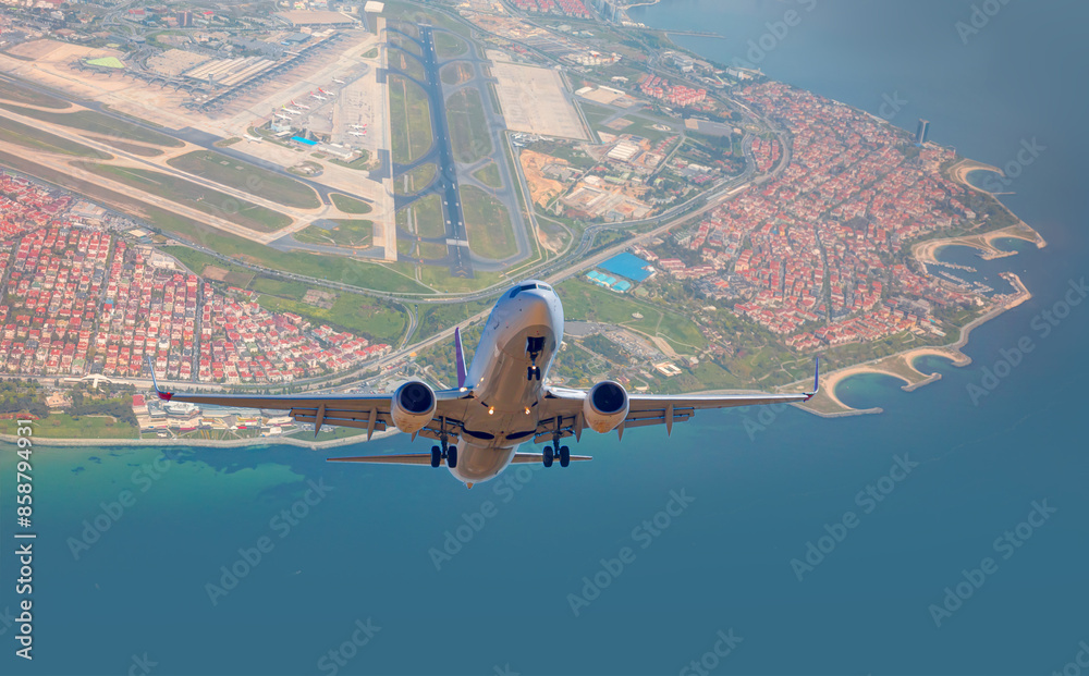 Wall mural commerical passenger plane fly up over take-off runway from ataturk airport - istanbul, turkey