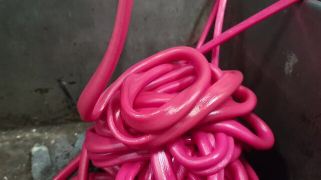 Material Polymers red plastic rubber polyethylene melted being pipe