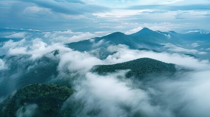 Obraz premium Scenic mountain view. Aerial cloudscape with clouds rolling over foggy mountain ridges AI generated